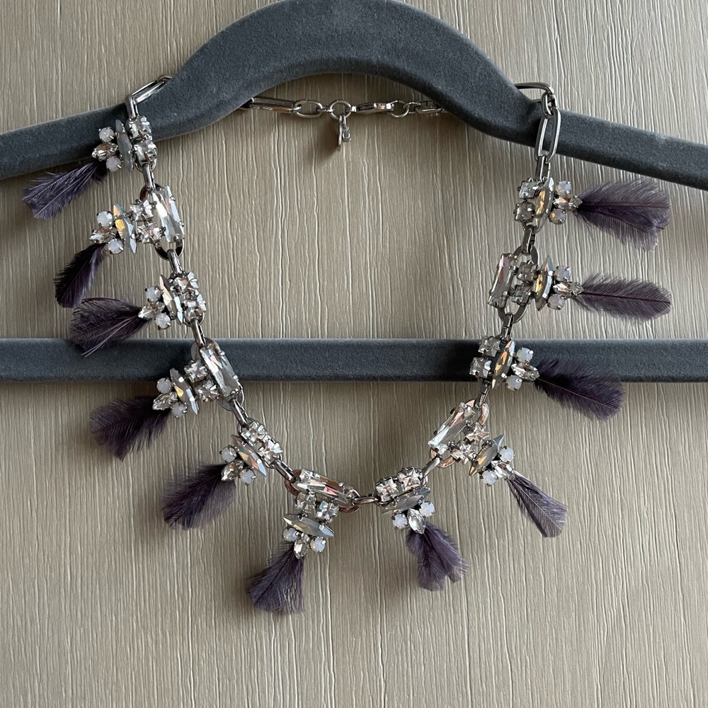 Embellished necklace with purple feathers.